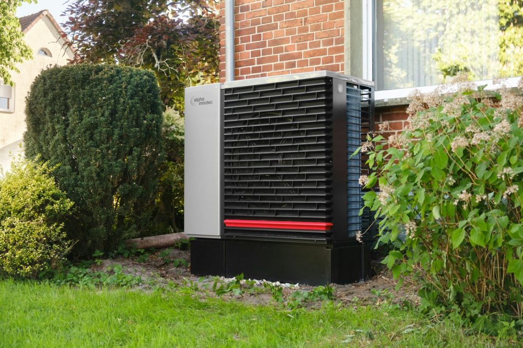 Outdoor heat pump unit installed beside a home